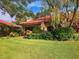 Charming single-story home boasts lush landscaping and a vibrant red tile roof at 5027 Kestral Park Dr # 64, Sarasota, FL 34231