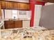 Well-lit kitchen featuring granite countertops, wood cabinets, and modern appliances at 5027 Kestral Park Dr # 64, Sarasota, FL 34231