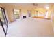 Spacious living room featuring a fireplace, windows, and carpet at 5027 Kestral Park Dr # 64, Sarasota, FL 34231