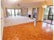 Bright living room featuring parquet floors, fireplace, and large windows at 5027 Kestral Park Dr # 64, Sarasota, FL 34231