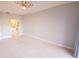 Spacious carpeted main bedroom with attached bath visible through doorway at 5027 Kestral Park Dr # 64, Sarasota, FL 34231