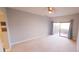 Spacious carpeted main bedroom with sliding glass door to outside patio at 5027 Kestral Park Dr # 64, Sarasota, FL 34231