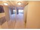 Hallway through mirrored closet doors leading into the carpeted main bedroom at 5027 Kestral Park Dr # 64, Sarasota, FL 34231