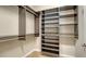 Spacious walk-in closet with custom built-in shelving and rods at 11741 Brookside Dr, Bradenton, FL 34211