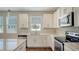 White kitchen cabinets and granite countertops at 11741 Brookside Dr, Bradenton, FL 34211