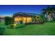 Landscaped backyard with pool and screened enclosure at dusk at 12663 Fontana Loop, Bradenton, FL 34211