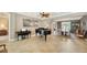 Open living area with elegant piano and view to dining area at 12663 Fontana Loop, Bradenton, FL 34211