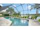 Inviting screened pool with lake view and patio furniture at 12663 Fontana Loop, Bradenton, FL 34211