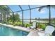 Screened pool area with lake view and seating at 12663 Fontana Loop, Bradenton, FL 34211