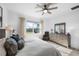 Main bedroom with large window, ceiling fan, and ample closet space at 10646 Spring Tide Way, Parrish, FL 34219