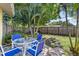 Outdoor patio area with mature trees and a fenced yard provides a tranquil backyard space at 2522 Fruit Tree Dr, Sarasota, FL 34239