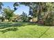 Large green backyard with mature trees provides lots of room for outdoor enjoyment at 2522 Fruit Tree Dr, Sarasota, FL 34239