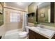 Well-lit bathroom with vanity, framed mirror, shower with tub, and tiled walls at 2522 Fruit Tree Dr, Sarasota, FL 34239