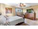 Cozy bedroom featuring a ceiling fan, neutral walls, traditional furniture, and natural light from the window at 2522 Fruit Tree Dr, Sarasota, FL 34239