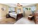 Cozy bedroom with neutral walls, traditional furniture, ceiling fan, and natural light from two windows at 2522 Fruit Tree Dr, Sarasota, FL 34239