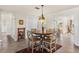 This dining area features a classic round wood table, seating for four, and natural light from adjacent rooms at 2522 Fruit Tree Dr, Sarasota, FL 34239