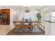 Dining area featuring a wooden table, stylish chairs, and modern lighting fixture with a view outside at 2522 Fruit Tree Dr, Sarasota, FL 34239