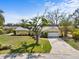 Inviting one-story yellow home with a two-car garage, beautiful yard, and mature landscaping at 2522 Fruit Tree Dr, Sarasota, FL 34239