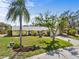 Charming single-story yellow house with a well-manicured lawn and mature trees at 2522 Fruit Tree Dr, Sarasota, FL 34239