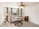 Bright living room with a ceiling fan, tile flooring, natural light, and neutral decor at 2522 Fruit Tree Dr, Sarasota, FL 34239