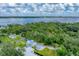 Wide aerial view showing waterfront property and lush surroundings at 3101 Riverview Blvd, Bradenton, FL 34205