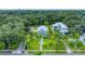 Aerial view of a stunning house with a large lawn and palm trees at 3101 Riverview Blvd, Bradenton, FL 34205