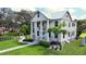 Two-story house with a white exterior, columned porch, and landscaped yard at 3101 Riverview Blvd, Bradenton, FL 34205