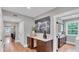 Light-filled hallway with hardwood floors, built-in cabinetry, and access to other rooms at 3101 Riverview Blvd, Bradenton, FL 34205