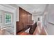 Charming hallway with wood paneling and hardwood floors at 3101 Riverview Blvd, Bradenton, FL 34205