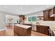 Modern kitchen with a large island, stainless steel appliances, and dark wood cabinetry at 3101 Riverview Blvd, Bradenton, FL 34205