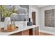 Stylish wet bar with quartz countertop, dark wood cabinets, and decorative accents at 3101 Riverview Blvd, Bradenton, FL 34205