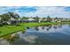 Aerial view of home showcasing a lakefront location and lush landscaping at 4043 Caddie E Dr, Bradenton, FL 34203