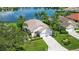 An aerial view of a single-Gathering home with a two-car garage and lake view at 4043 Caddie E Dr, Bradenton, FL 34203