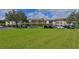 Condo building with covered parking and lush green lawn at 6503 Stone River Rd # 302, Bradenton, FL 34203