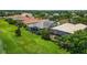 Aerial view showcasing a home with a private pool and lush landscaping at 14717 Leopard Creek Pl, Lakewood Ranch, FL 34202