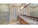 Bathroom with double vanity, granite countertop, and shower at 14717 Leopard Creek Pl, Lakewood Ranch, FL 34202