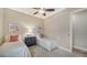 Bedroom with two twin beds, dresser, and window with shutters at 14717 Leopard Creek Pl, Lakewood Ranch, FL 34202