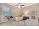 Bright bedroom featuring twin beds, a dresser, and window at 14717 Leopard Creek Pl, Lakewood Ranch, FL 34202