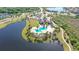 Community pool and clubhouse near a lake at 14717 Leopard Creek Pl, Lakewood Ranch, FL 34202