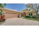 Inviting home exterior featuring a brick driveway and attached garage at 14717 Leopard Creek Pl, Lakewood Ranch, FL 34202