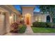 Inviting entryway to a charming house at dusk at 14717 Leopard Creek Pl, Lakewood Ranch, FL 34202