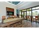Relaxing game room with pool table, large TV, and views of the resort pool at 14717 Leopard Creek Pl, Lakewood Ranch, FL 34202