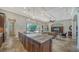 Open concept kitchen with island seating and views to the living room at 14717 Leopard Creek Pl, Lakewood Ranch, FL 34202