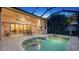 Covered patio with pool access, outdoor kitchen, and dining area at 14717 Leopard Creek Pl, Lakewood Ranch, FL 34202