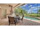 Enjoy the view from this screened patio with pool and grill at 14717 Leopard Creek Pl, Lakewood Ranch, FL 34202