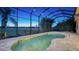 Kidney-shaped pool with a screened enclosure and golf course views at 14717 Leopard Creek Pl, Lakewood Ranch, FL 34202
