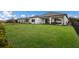 Expansive green backyard perfect for outdoor activities, framed by fencing and the home's elegant exterior at 5510 Panella Ct, Palmetto, FL 34221