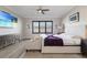 Comfortable bedroom with a TV, large window, and neutral colors at 5510 Panella Ct, Palmetto, FL 34221