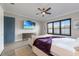 Inviting bedroom with a ceiling fan, TV, plantation shutters, and a cozy sofa at 5510 Panella Ct, Palmetto, FL 34221