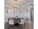 Dining room with round table, modern chandelier, and sophisticated decor at 5510 Panella Ct, Palmetto, FL 34221